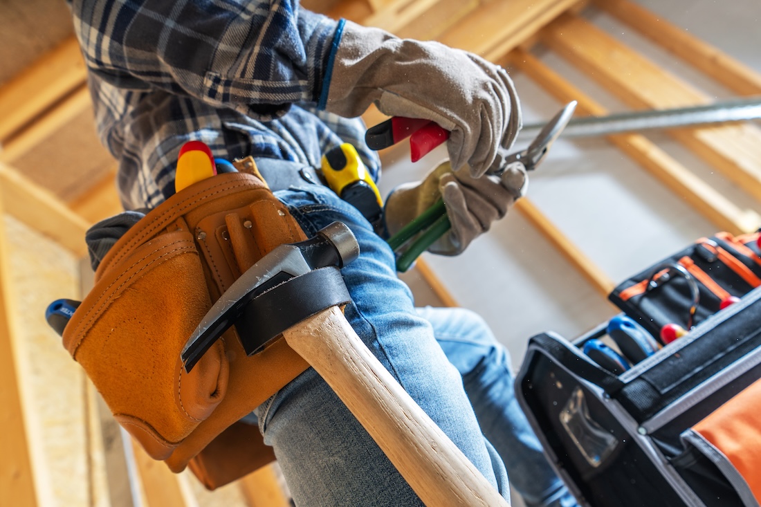 Pine Belt Repair Co. craftsman fitting a door hinge